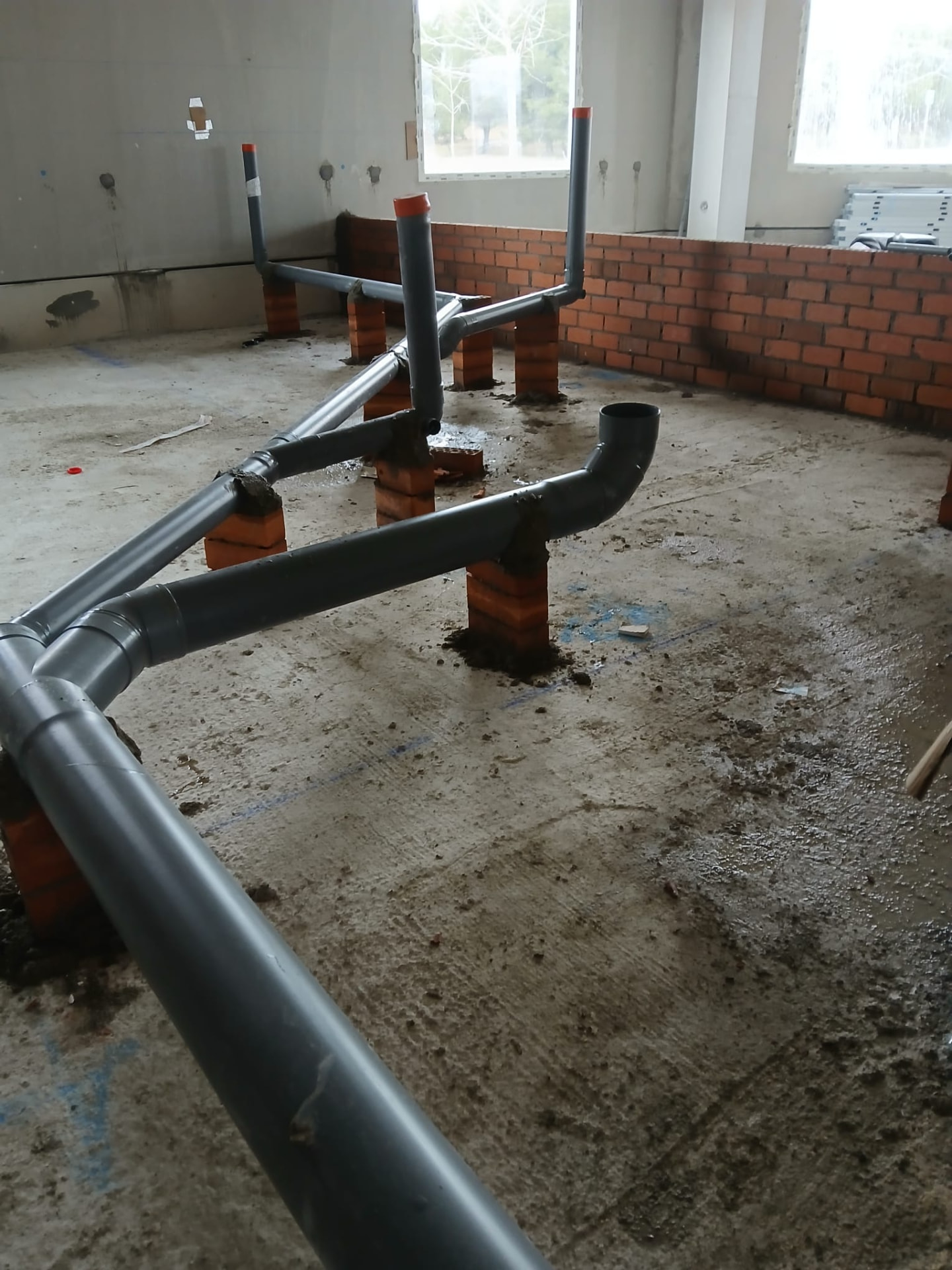 Instalación de tuberías de desagüe de PVC en el suelo de una vivienda en Moralzarzal